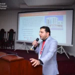 Speaker presenting Computer Xperts company history and Alibaba partnership at export seminar.